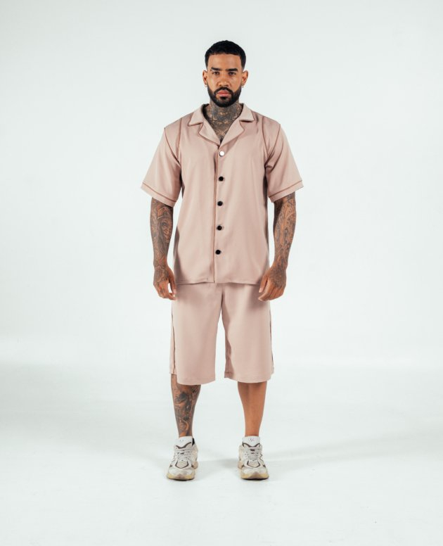 Comfortable beige satin loungewear set with short-sleeve shirt and knee-length shorts, perfect for casual wear or relaxing at home. Stylish and trendy, designed for modern comfort.